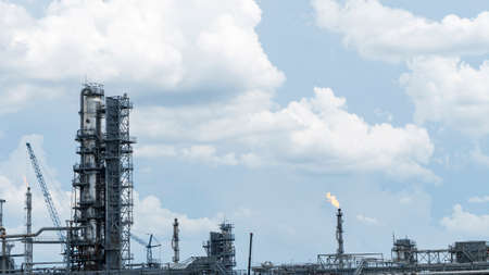 Distillation tower or column on blue sky with clouds background. Oil refinery plant. Refining complex.の写真素材