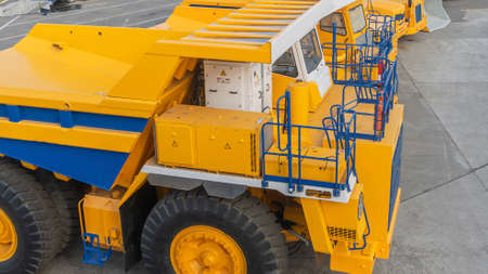 Heavy mining dump trucks are at the factory. Giant mining truck after being from the conveyor is...