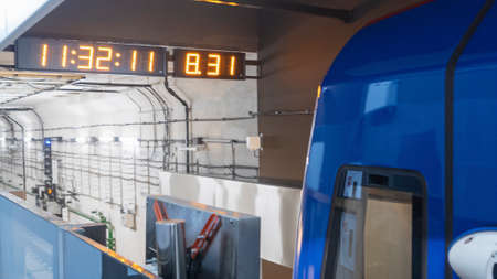 Modern subway passenger blue train at metro station. Perspective front view of subway tunnel.