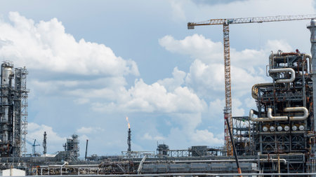 Construction with cranes of a large blue chemical plant at an oil refinery, petrochemical plant.