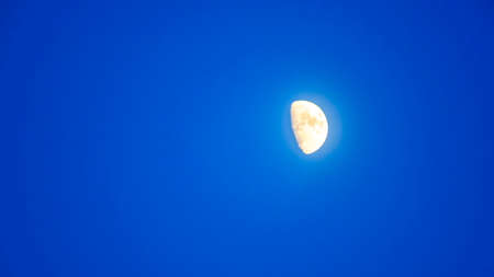 Crescent in the blue evening cloudless sky. Moon in the sky. Design concept. Space for text.