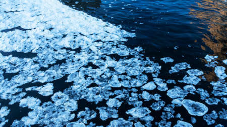 Fast ice. Ice floes background of winter river. Breaking and melting ice. Spring background.