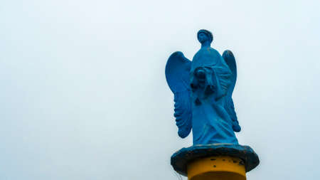 Low angle view of a transparent statue of blue angel. Religion or LGBTQ symbol.の写真素材