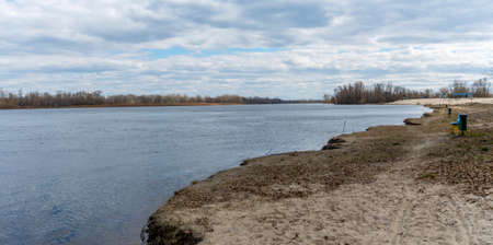 River beach in early spring. Empty embankment.