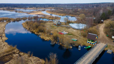 Aerial landscape view on river with flooded meadows and beautiful fields.