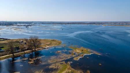 Aerial view of river flood. Beautiful flooded meadow. Flying above beautiful Pripyat river when the river is full of water at spring. Nature concept.の写真素材