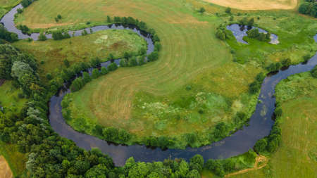 Aerial landscape of winding river in green field, top view of beautiful nature background from...