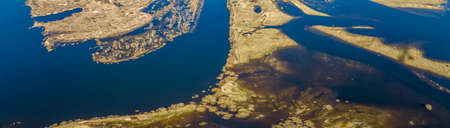 Aerial landscape of winding river in green field, top view of beautiful nature background from drone.の写真素材