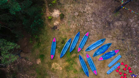 Kayaks on the river bank. Tourist kayaking pier. Tourist camp, river pleasure boat pier during a tourist trip.の写真素材