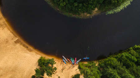 Kayaks on the river bank. Tourist kayaking pier. Tourist camp, river pleasure boat pier during a tourist trip.の写真素材