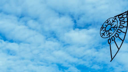 Light bulbs garlands on a background of blue sky. Abstract composition for design. Strange objects on the background of the blue cloudy sky.の写真素材