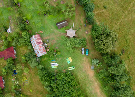 Top view camping in the holidays. Tourist tents in the forest on the river bank. Aerial view.の写真素材