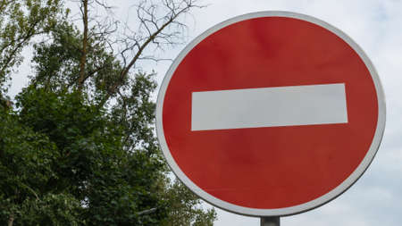 No Entry Traffic Road Sign. Red with white color round road sign on a background of blue sky with...