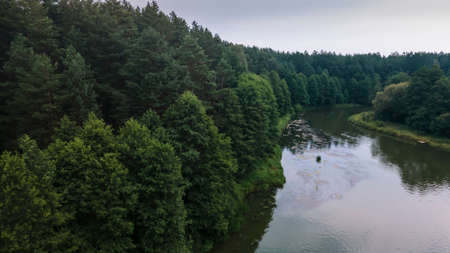 Forest with a winding river at sunset. Aerial photography with a drone.の写真素材
