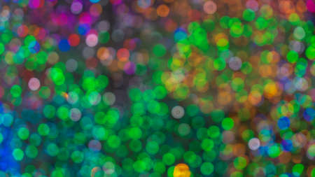 Christmas lights. Festive New Year blurred pink, purple and black background. Beautiful sparkling...