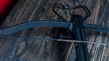 Part of modern compound crossbow handgun on the dark wooden backgroundの写真素材