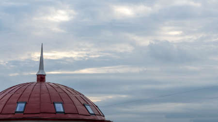 The spire of the office building against the dramatic sky. Cityscape from above. Space for text.の写真素材