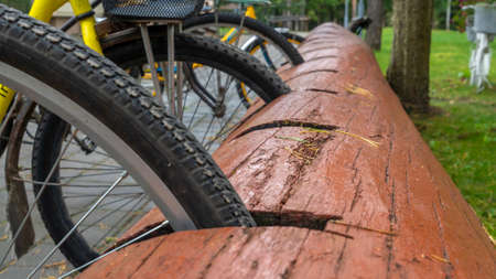 Rustic bike rack. Bicycle Parking Stand Made From the Trunk. bicycle parking was made from a large log.の写真素材