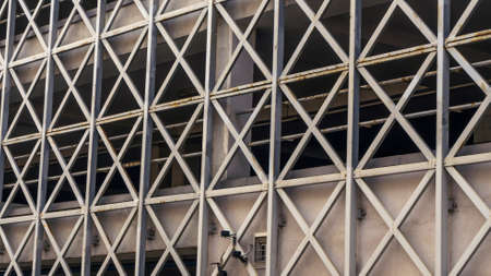 Car parking building with metal grille. Abstract steel surface with copy space. Urban concept. Image for design.の写真素材