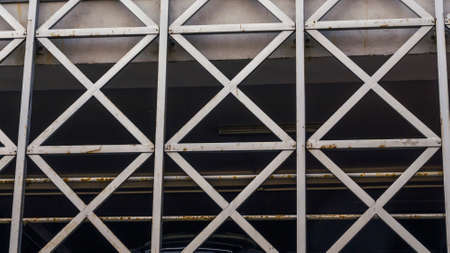Car parking building with metal grille. Abstract steel surface with copy space. Urban concept. Image for design.の写真素材