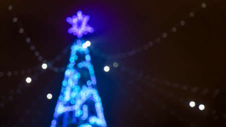 Christmas holiday background. Christmas tree in shining garland in blur. Happy New Year concept.の写真素材