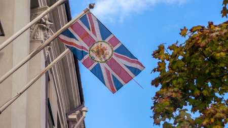 Great Britain flag on facade of old building on blue sky background. With copy space. Patriotic concept.の写真素材
