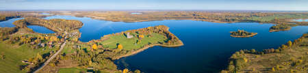 Autumn forest and lake. View from the top. Aerial Photo of an Island in Lake on Sunny Autumn Day....