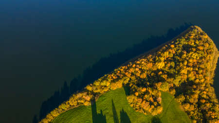 Autumn forest and lake. View from the top. Aerial Photo of an Island in Lake on Sunny Autumn Day. Nature concept.の写真素材