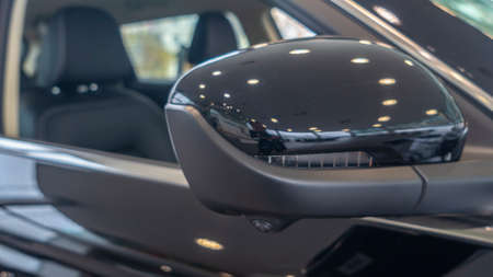 Close-up front view of rearview mirror and modern car interior. A rear view mirror on a car door....