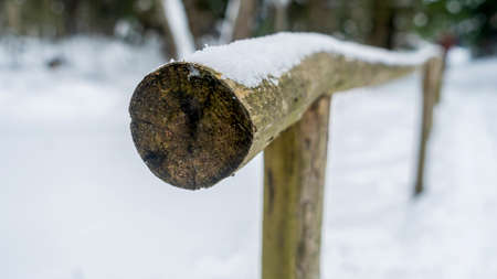 Winter nature with a pole fence. Snow and Icicles on fence at winter. Winter concept.の写真素材