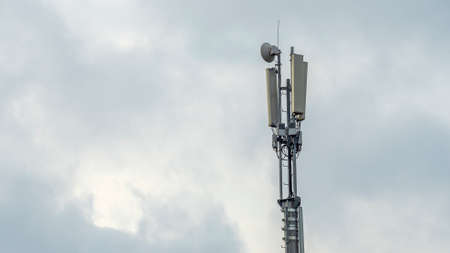Tower with mobile operator antennas on the dramatic sky background. Tower hosted equipment cellula....