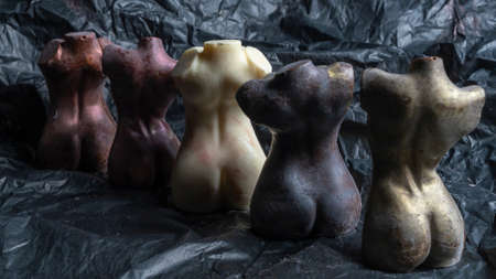 Chocolate figurines in the form of a naked female body. LGBT concept. Unusual sweets. Image for LGBTQ design. Texture and background.の写真素材