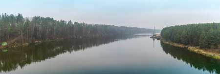 Floating crane on the river. Dredging crane working near shore. Conservation river flow. Nature,...