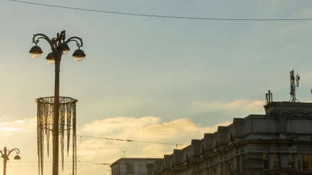 Panoramic view of silhouettes of buildings and street lights at sunset in the historical center of city. Urban concepts.の写真素材