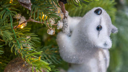 Toy squirrel or gopher sitting on a fluffy fir branches. Merry Christmas and Happy New Year Greeting Card Design. The concept of New Year and Christmas. Festive decoration.の写真素材