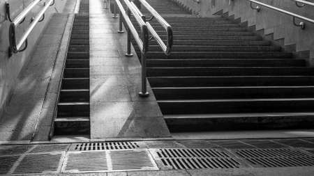 White and black image of staircase in the underpass. Staircase to freedom. The rays of the sun on the steps. New life concepts. Abstract background.の写真素材
