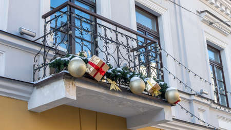The balcony of the old building is decorated with Christmas and New Year decor. Xmas concepts.の写真素材