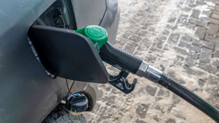Petrol pump filling. Gas nozzle pumping gas into a car. Car refueling on a petrol station.の写真素材