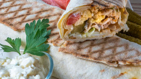 Shawarma chicken roll. Fresh roll of thin lavash or pita bread filled with grilled meat, cheese,...