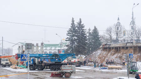 View of the construction site with snowy weather. Construction is a general term meaning the art and...