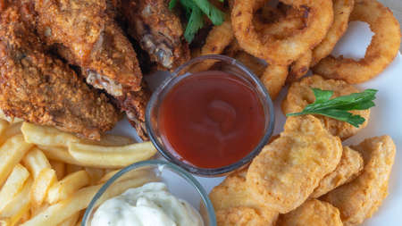 Snack platter - cheese sticks, chicken nugget, onion rings, french fries mix of snacks and sauces ....