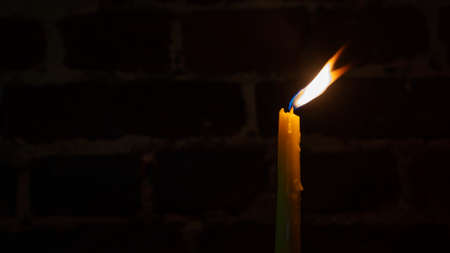 Candle flame close-up on a dark background. Melted Wax Candle light border design. long exposure. Darkness. Burning at Night, Candlelight. widescreenの写真素材