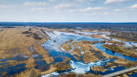 The top view on the flood of the river, bridge and forest. High water at early spring. nature background.の写真素材