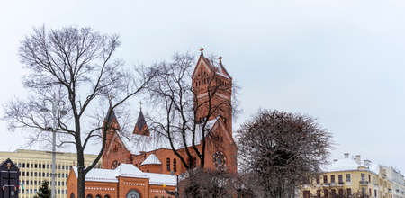 Catholic Church of St. Simon and St. Helena, Red Church, in Independence Square in Minsk in winter. Worship and heritage concepts.の写真素材