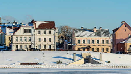 Panoramic view of old building in historical center of Minsk. Historical building near the frozen river. Winter daytime in the Trinity Suburb in Minsk. heritage concepts.の写真素材
