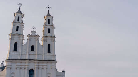 Catholic cathedral in Baroque style against the sky. An old tall building with two towers. heritage and worship concepts.の写真素材