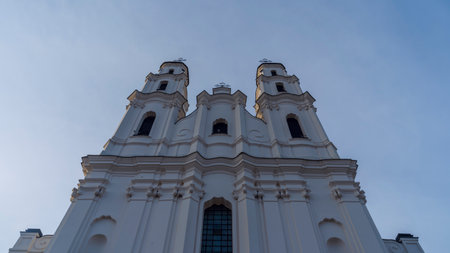 Catholic cathedral in Baroque style against the sky. An old tall building with two towers. heritage and worship concepts.の写真素材