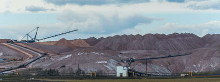 Mountains of empty ore when mining potassium. Transportation of an empty rock to a dump. View of the large production mountains of waste ore. Extraction of salt and other minerals.の写真素材
