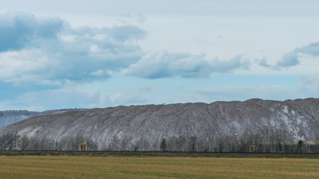 Mountains of empty ore when mining potassium. Transportation of an empty rock to a dump. View of the...