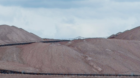 Mountains of empty ore when mining potassium. Transportation of an empty rock to a dump. View of the large production mountains of waste ore. Extraction of salt and other minerals.の写真素材